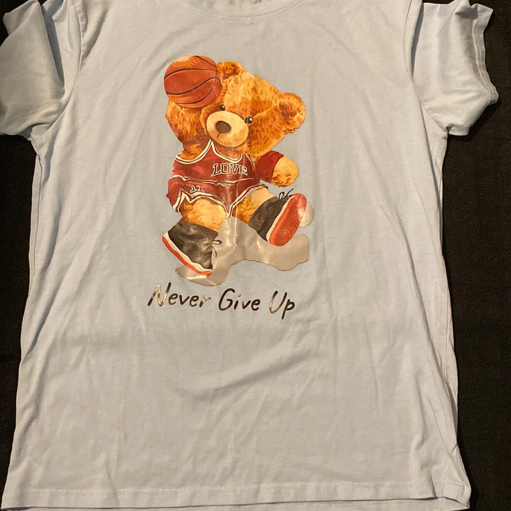 I am selling , A middle sized blue shirt with a basketball bear